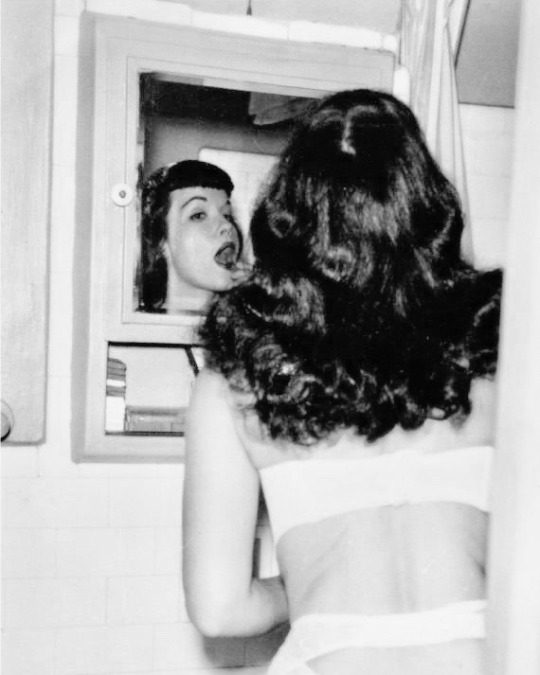 Bettie Page applying her makeup, 1950s