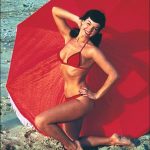 Bettie in red on the beach