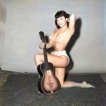What is Bettie Page ding with that guitar