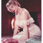 Eve Meye in a nightie in front of a fire place Eve Meye